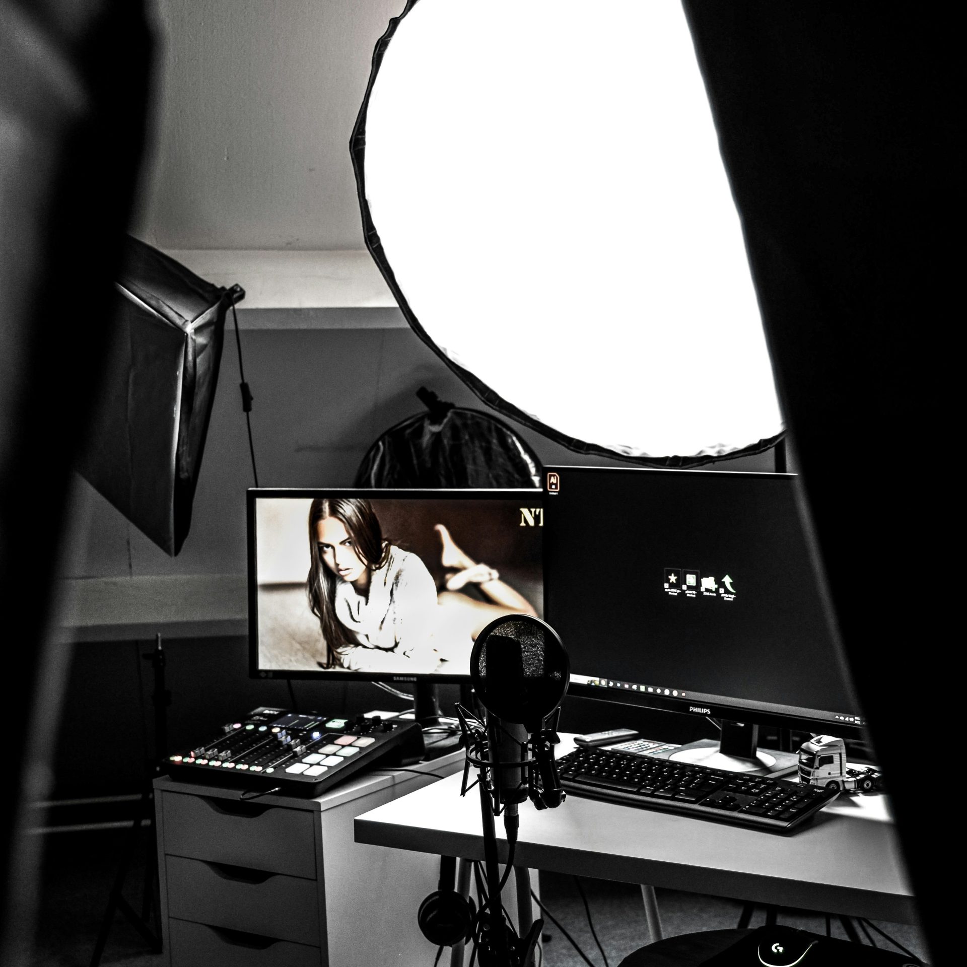a black and white photo of a desk with a monitor and keyboard